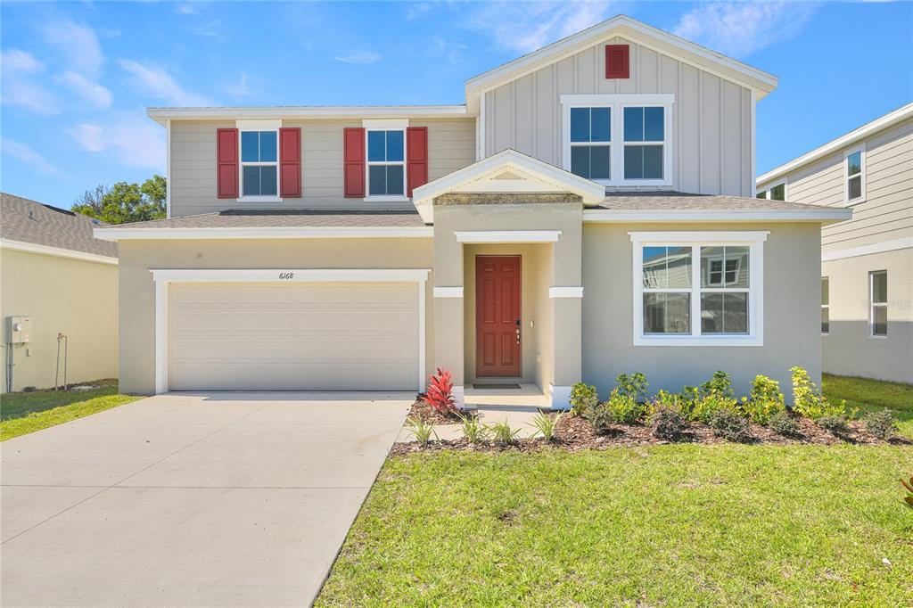 6168 Southwest 64th Terrace Ocala, FL 34474 - Photo 2 of 24 a front view of a house with a yard