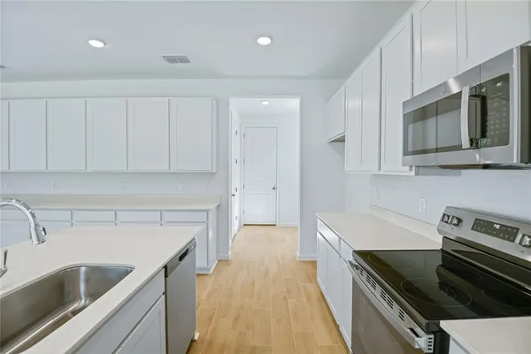 a kitchen with a sink stove and microwave