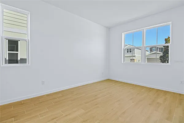 a view of a kitchen with stainless steel appliances wooden floor and a window