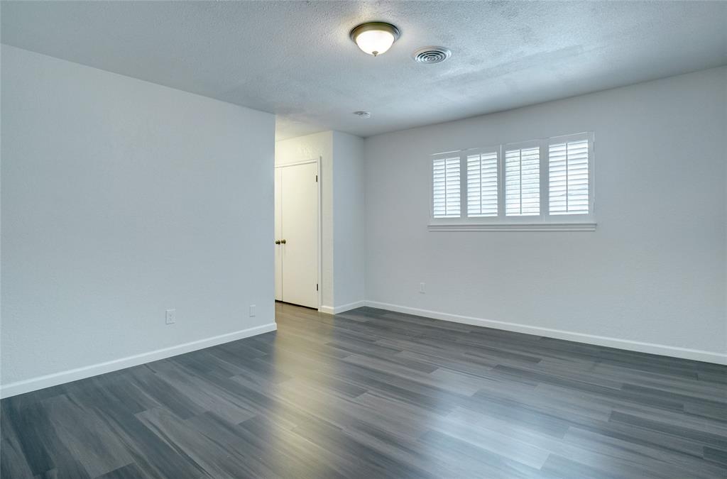 8900 Random Road Fort Worth, TX 76179 - Photo 12 of 18 an empty room with wooden floor and windows
