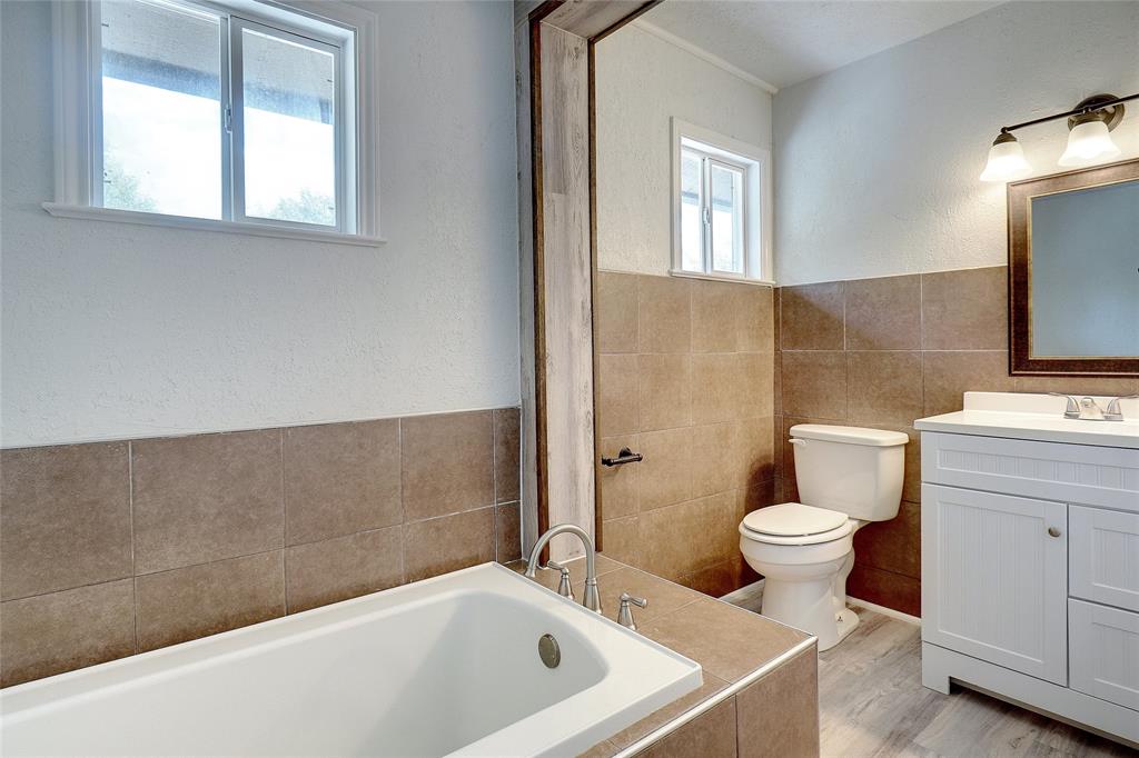 8900 Random Road Fort Worth, TX 76179 - Photo 14 of 18 a bathroom with a sink toilet a mirror and bathtub