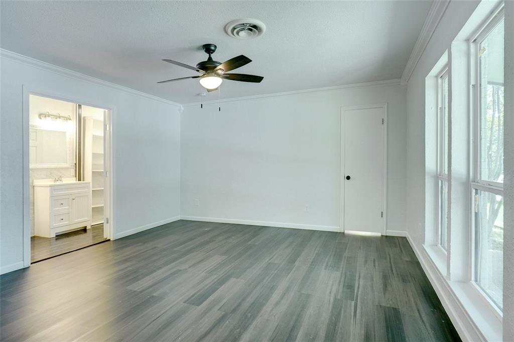 8900 Random Road Fort Worth, TX 76179 - Photo 8 of 18 a view of empty room with wooden floor and fan