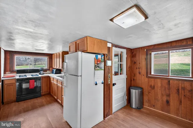 a kitchen with a stove a sink and a refrigerator