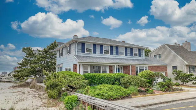 a front view of a residential houses with yard