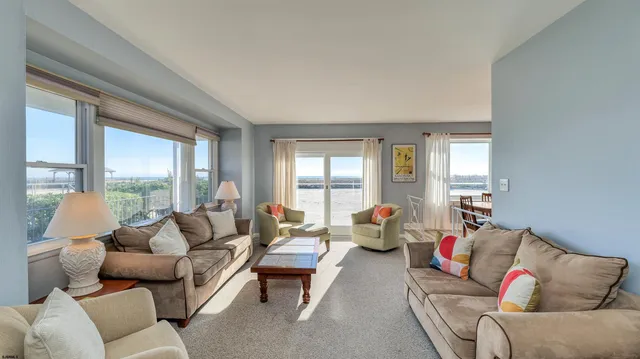 a large kitchen with stainless steel appliances kitchen island granite countertop a refrigerator and a stove top oven