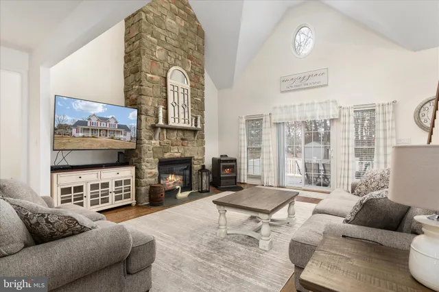 a living room with fireplace furniture and a flat screen tv