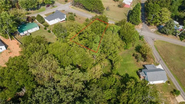 an aerial view of residential house with pool and garden