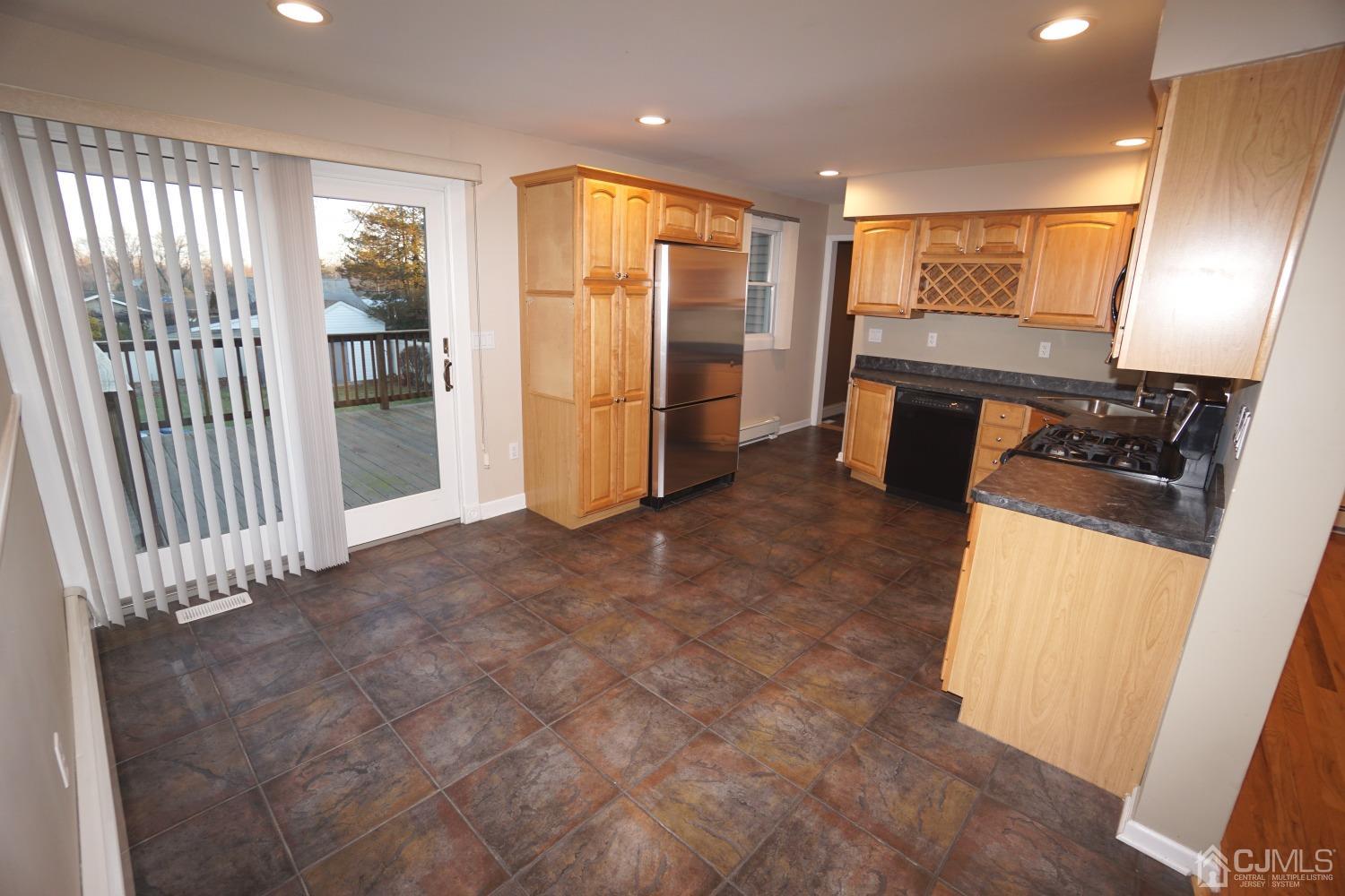 164 Normandy Road Colonia, NJ 07067 - Photo 14 of 47 a view of a kitchen with fridge and wooden floor