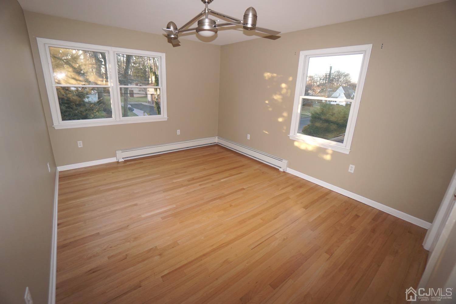 164 Normandy Road Colonia, NJ 07067 - Photo 29 of 47 an empty room with wooden floor and windows