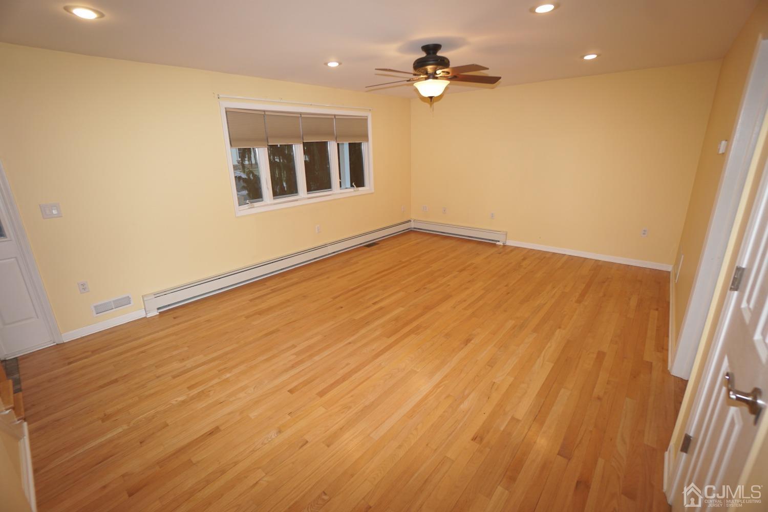 164 Normandy Road Colonia, NJ 07067 - Photo 10 of 47 wooden floor in an empty room with a window