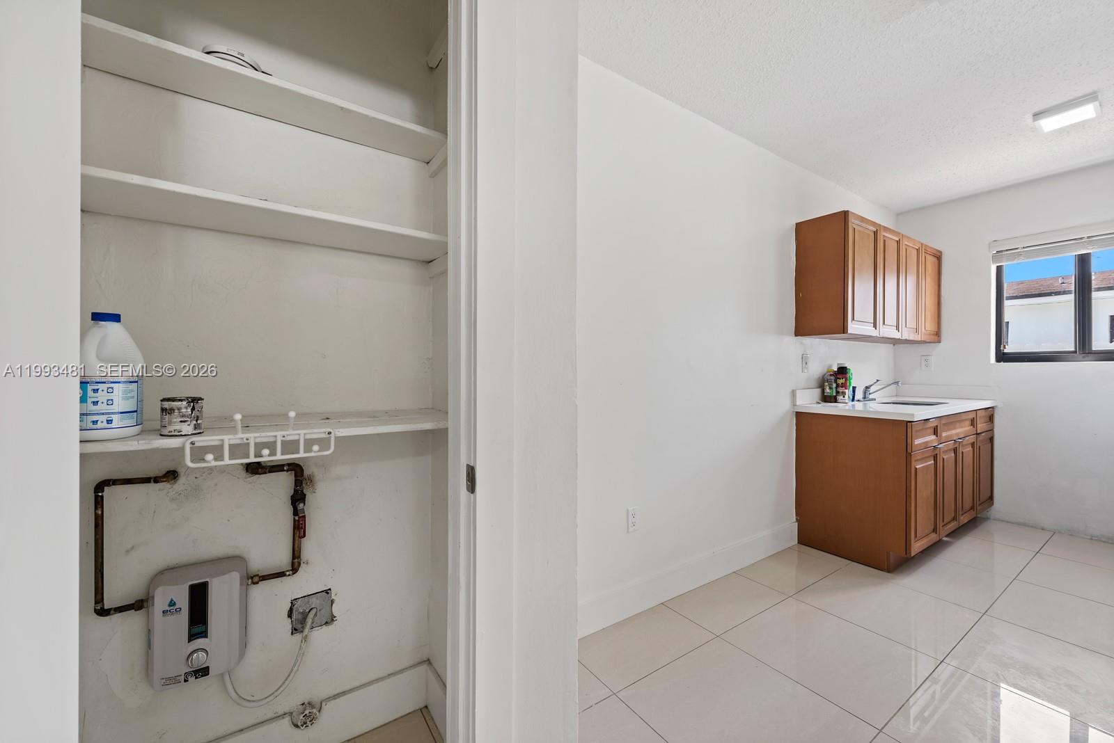 1911 Northwest 30th Street, Unit 4 Miami, FL 33142 - Photo 12 of 15 a bathroom with a sink and a mirror