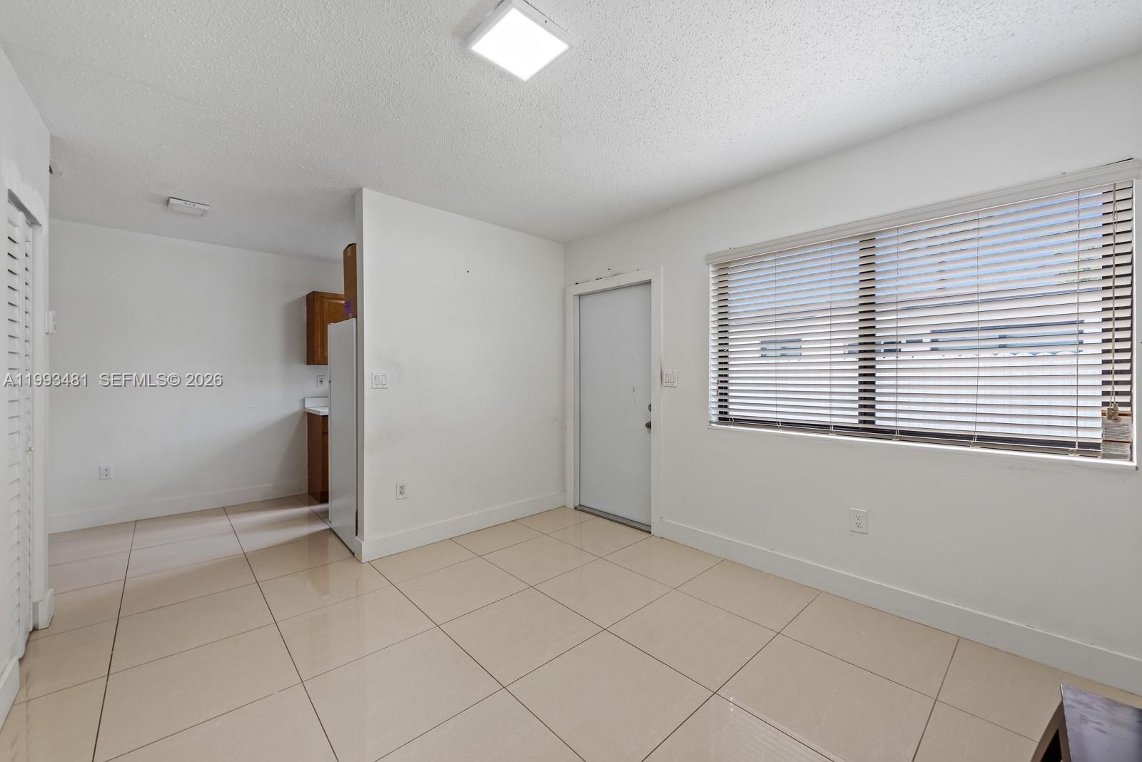 1911 Northwest 30th Street, Unit 4 Miami, FL 33142 - Photo 3 of 15 an empty room with windows