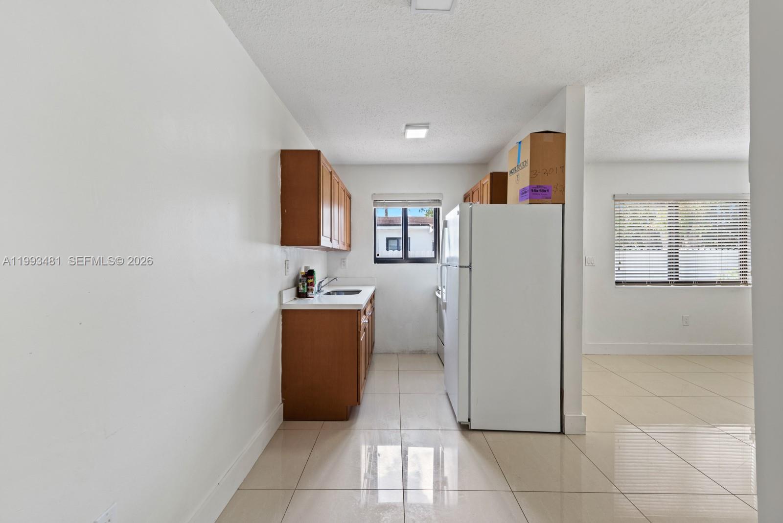 1911 Northwest 30th Street, Unit 4 Miami, FL 33142 - Photo 7 of 15 a view of cabinets with wooden floor and electronic appliances