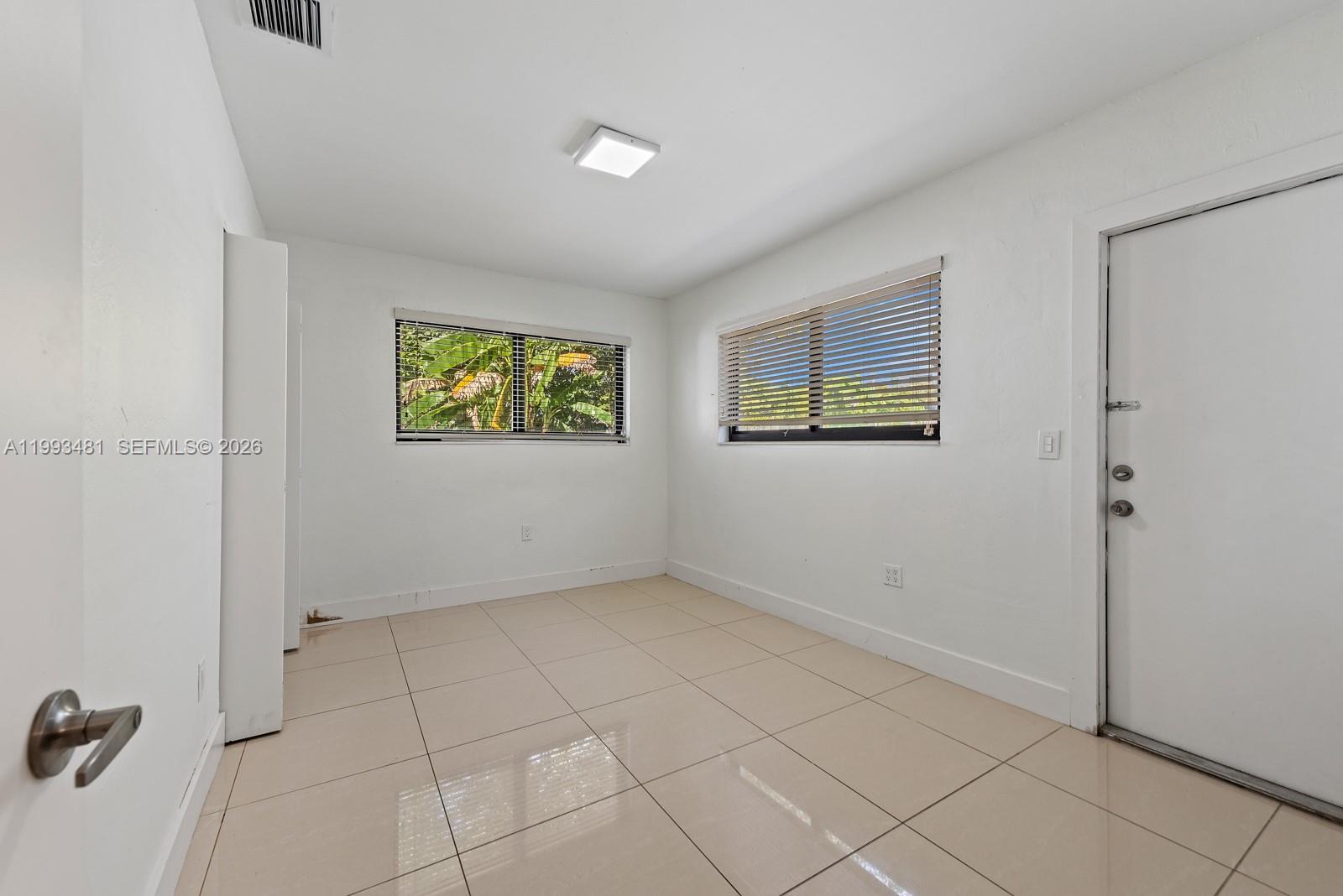 1911 Northwest 30th Street, Unit 4 Miami, FL 33142 - Photo 10 of 15 a view of an empty room with a window