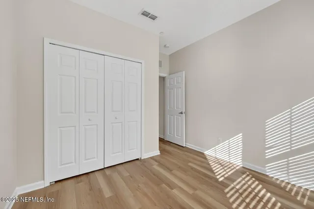 a bathroom with a granite countertop sink toilet a mirror and shower