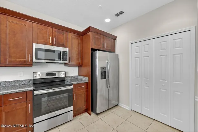 a kitchen with a sink stove and microwave