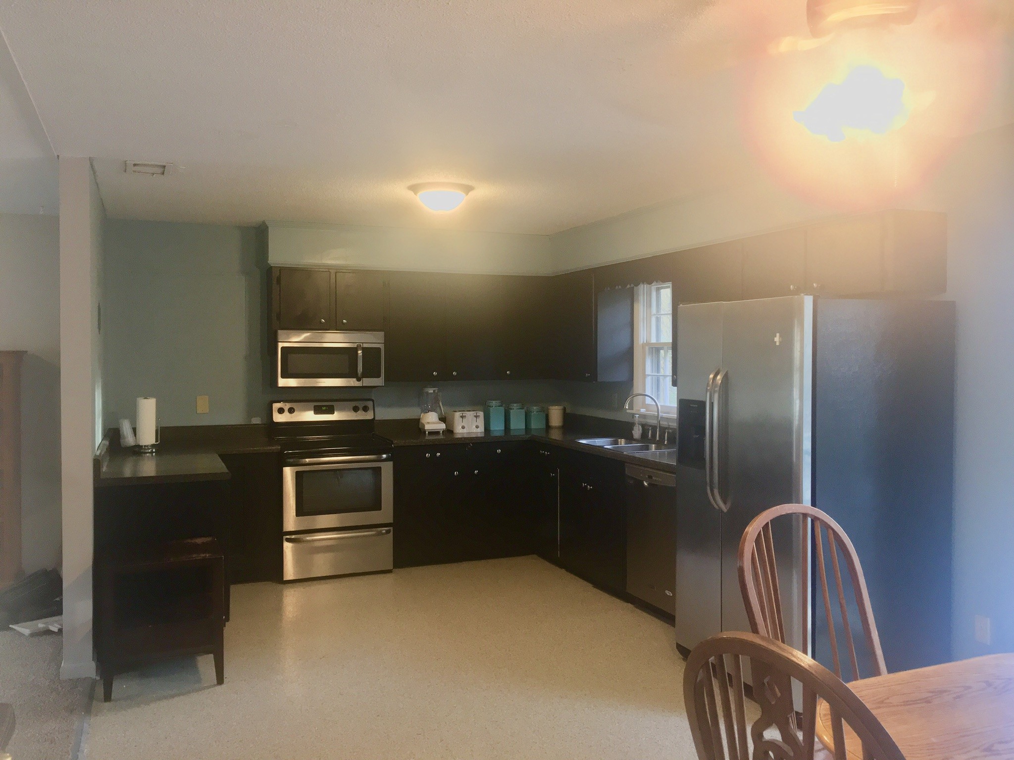 401 Prosser Road Lawrenceburg, TN 38464 - Photo 2 of 18 a kitchen with granite countertop stainless steel appliances and wooden cabinets
