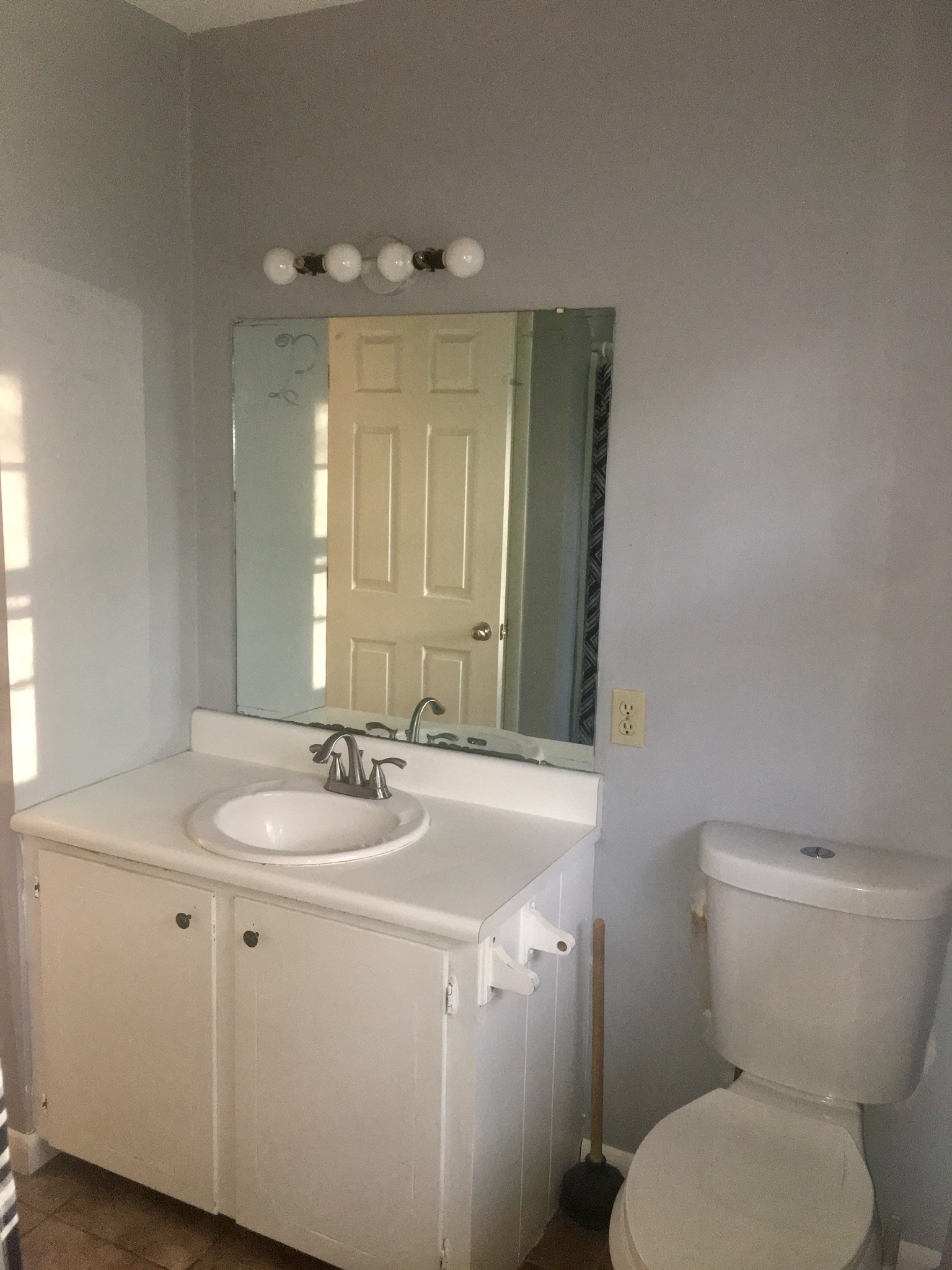 401 Prosser Road Lawrenceburg, TN 38464 - Photo 8 of 18 a bathroom with a granite countertop toilet sink and mirror