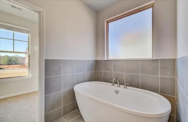 a white bath tub sitting next to a white sink