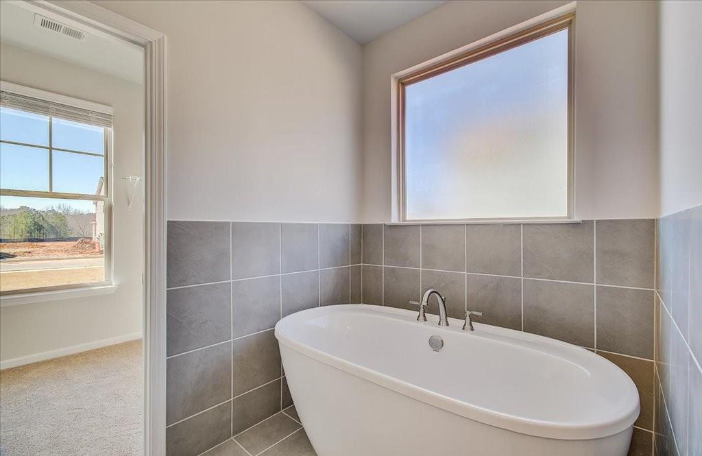 601 Button Grove Stockbridge, GA 30281 - Photo 11 of 37 a white bath tub sitting next to a white sink