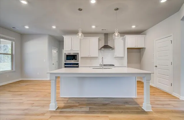a view of kitchen with kitchen island sink and refrigerator