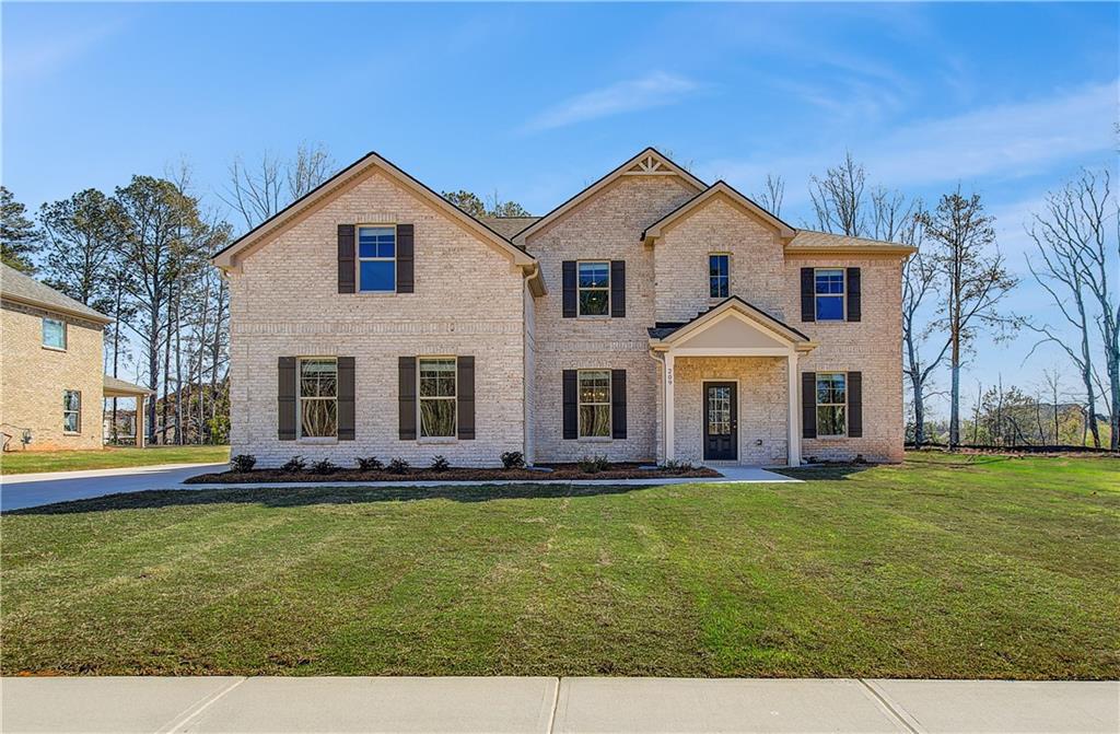 601 Button Grove Stockbridge, GA 30281 - Photo 2 of 37 a view of a white house with a big yard and large trees