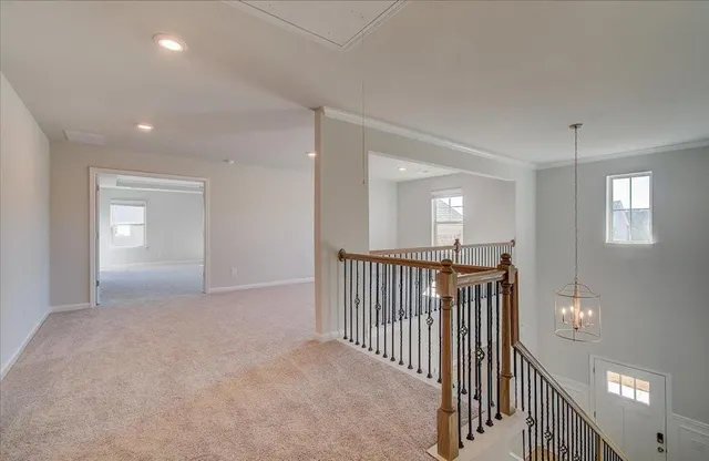 a view of a hallway with entryway to stairs