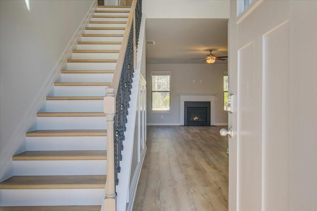 601 Button Grove Stockbridge, GA 30281 - Photo 4 of 37 a view of a hallway with wooden floor and fireplace