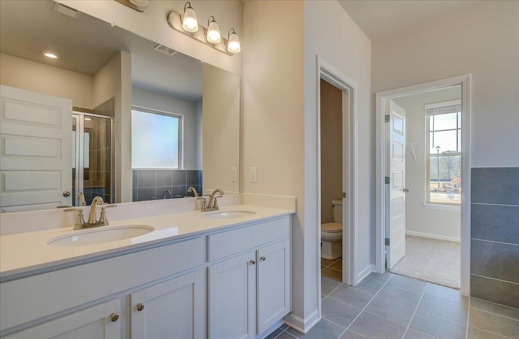601 Button Grove Stockbridge, GA 30281 - Photo 9 of 37 a bathroom with a double vanity sink and a mirror