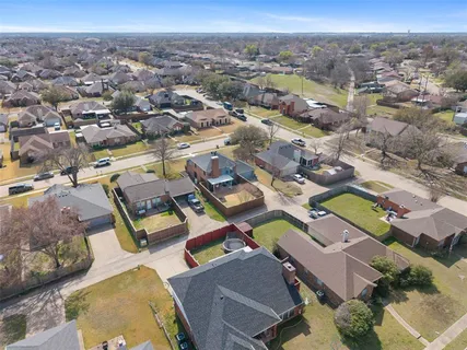 an aerial view of a residential houses with outdoor space