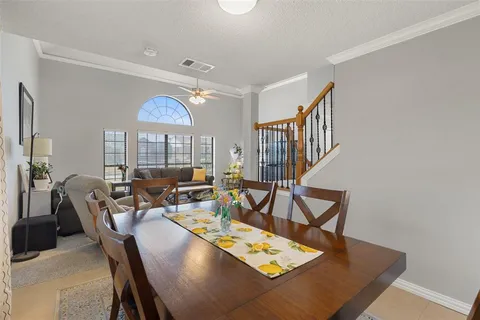 a view of a dining room and livingroom with furniture wooden floor a rug and a chandelier