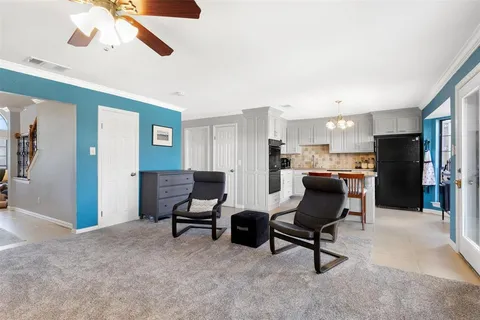 a view of a workspace with furniture and a ceiling fan