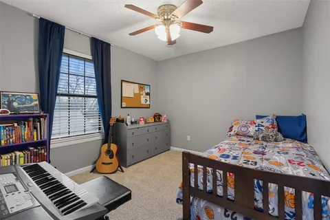 a bedroom with furniture and a book shelf