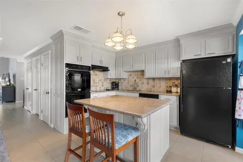 a kitchen with a refrigerator a stove a sink and a refrigerator