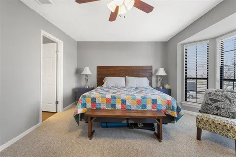 a bedroom with a bed a baby and a chandelier