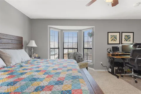 a bedroom with a bed and a desk