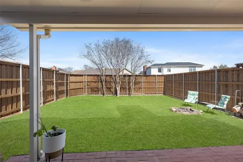 a view of a backyard with sitting area