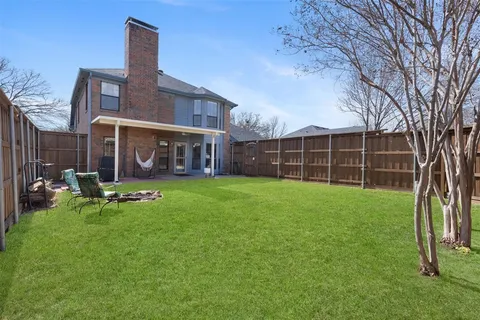 a view of a house with backyard porch and sitting area