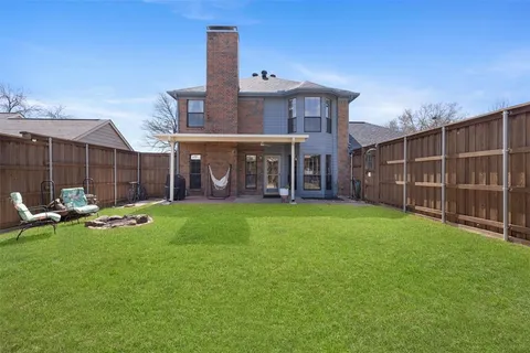 a view of a house with a yard and sitting area