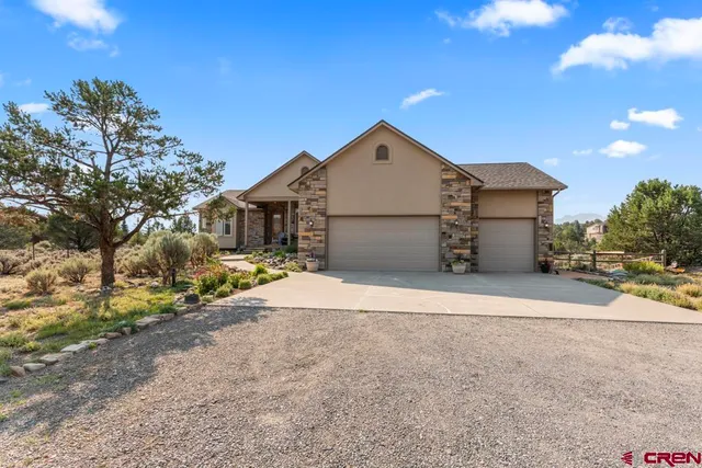 a view of a house with a yard and garage