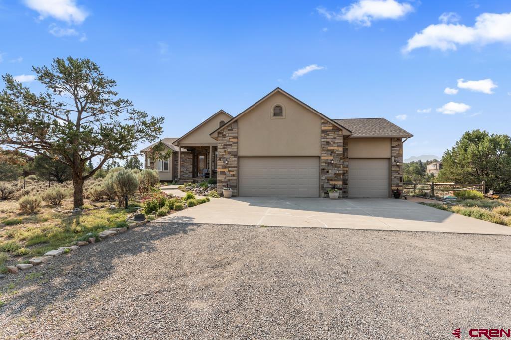 a view of a house with a yard and garage