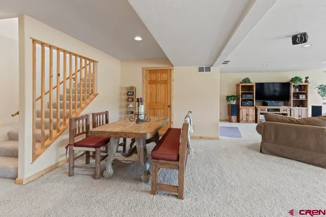 a dining room with furniture and wooden floor