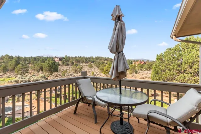 a view of a patio with chairs and floor to ceiling window