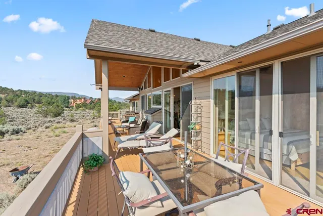 a balcony view with couple of chairs