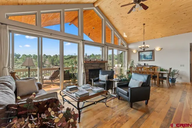 a living room with furniture a fireplace and a chandelier