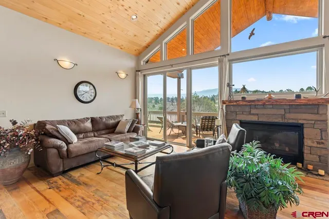 a living room with furniture a fireplace and a large window