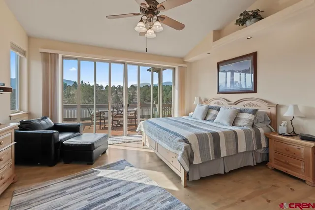 a spacious bedroom with a bed and a large window