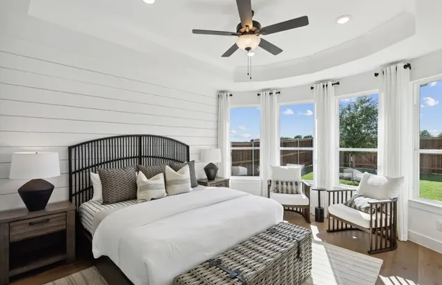 a bedroom with a large bed and a chandelier