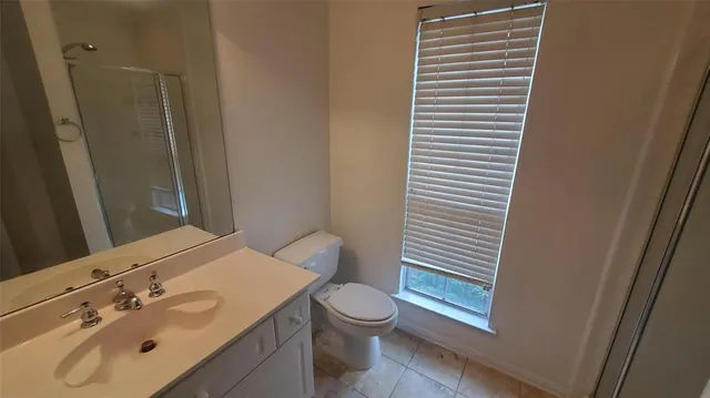 a bathroom with a sink a toilet and shower curtain