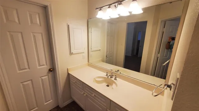 a bathroom with a double vanity sink a mirror and shower